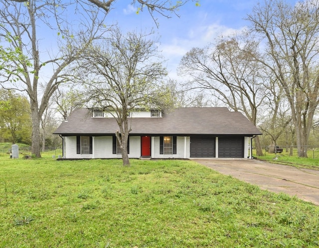 view of front of property featuring a front yard and a garage