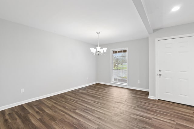 interior space with a notable chandelier, dark wood-type flooring, and beam ceiling