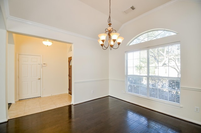 unfurnished room featuring lofted ceiling, wood-type flooring, crown molding, and a chandelier