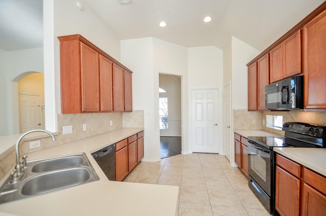 kitchen featuring decorative backsplash, sink, black appliances, and light tile patterned flooring