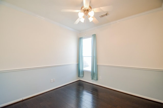 empty room with ceiling fan, dark wood-type flooring, and ornamental molding