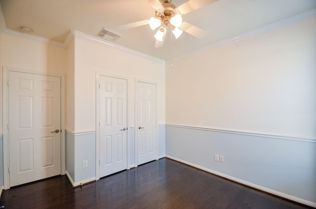 unfurnished bedroom featuring ceiling fan, dark hardwood / wood-style floors, and ornamental molding