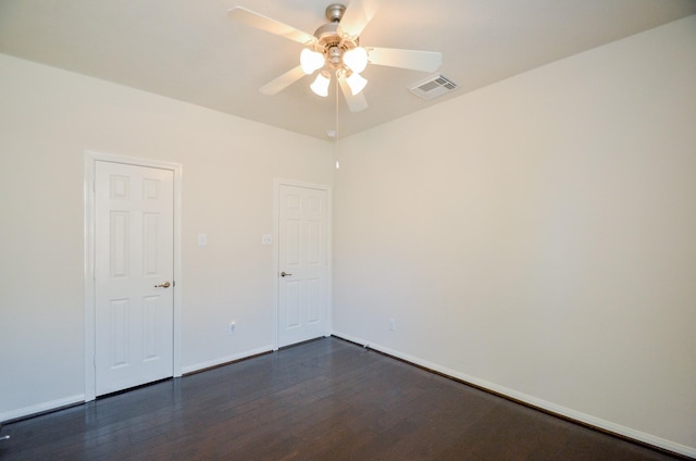 empty room featuring ceiling fan and dark hardwood / wood-style flooring