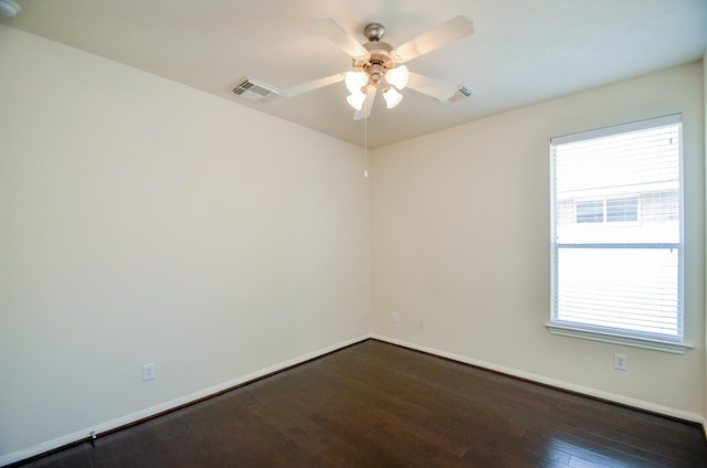 unfurnished room with ceiling fan and dark hardwood / wood-style flooring