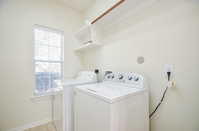 laundry room with separate washer and dryer and light tile patterned floors