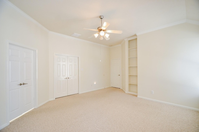 carpeted empty room with ceiling fan and ornamental molding