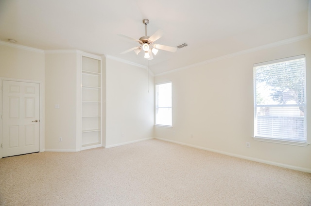 carpeted empty room featuring ceiling fan and ornamental molding