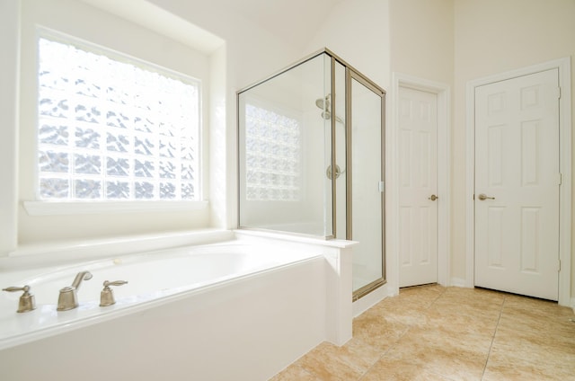 bathroom featuring shower with separate bathtub