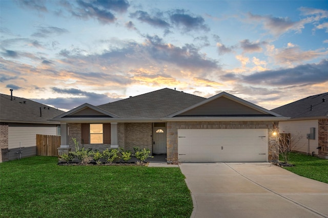 ranch-style home featuring a yard and a garage