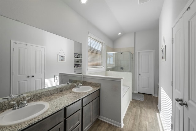 bathroom with vanity, lofted ceiling, an enclosed shower, and wood-type flooring