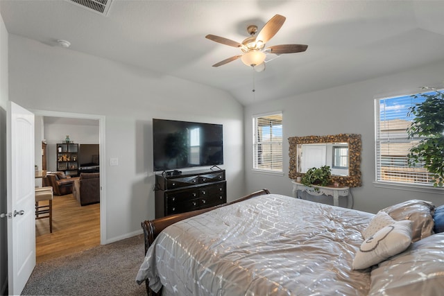 carpeted bedroom with ceiling fan and lofted ceiling