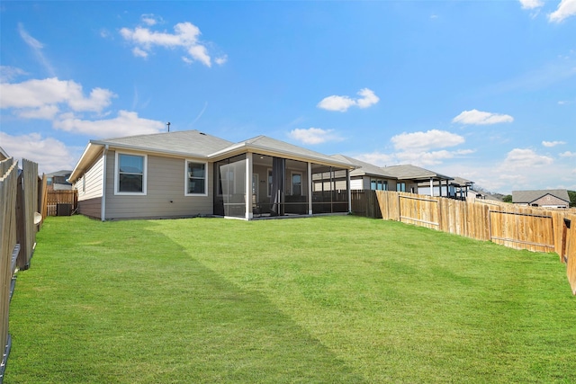 rear view of property featuring central AC, a yard, and a sunroom