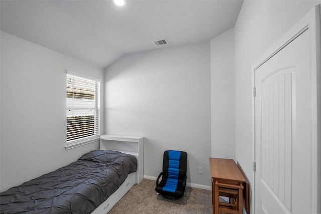 carpeted bedroom featuring lofted ceiling