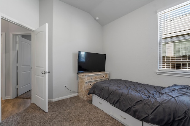 carpeted bedroom featuring lofted ceiling