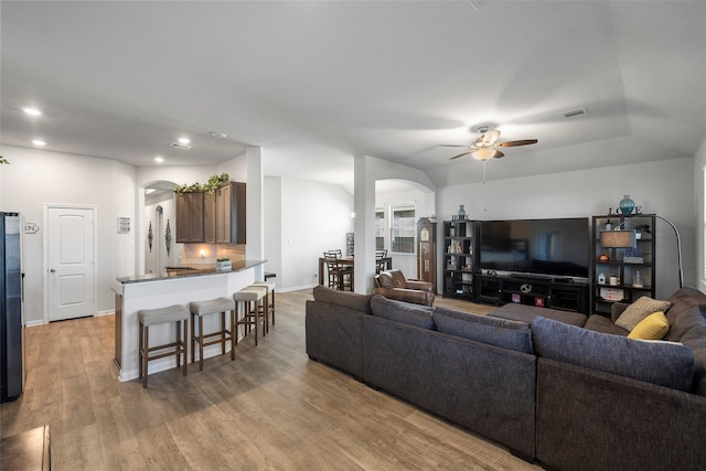 living room with light wood-type flooring and ceiling fan