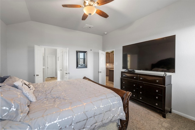 bedroom featuring lofted ceiling, connected bathroom, ceiling fan, and light colored carpet