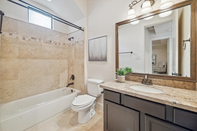 full bathroom with toilet, vanity, and tiled shower / bath