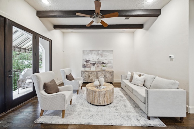 living room featuring ceiling fan, beamed ceiling, and dark hardwood / wood-style floors