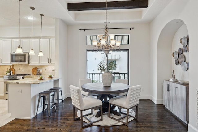 dining area featuring dark hardwood / wood-style flooring and a chandelier