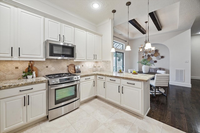 kitchen featuring white cabinetry, kitchen peninsula, and appliances with stainless steel finishes