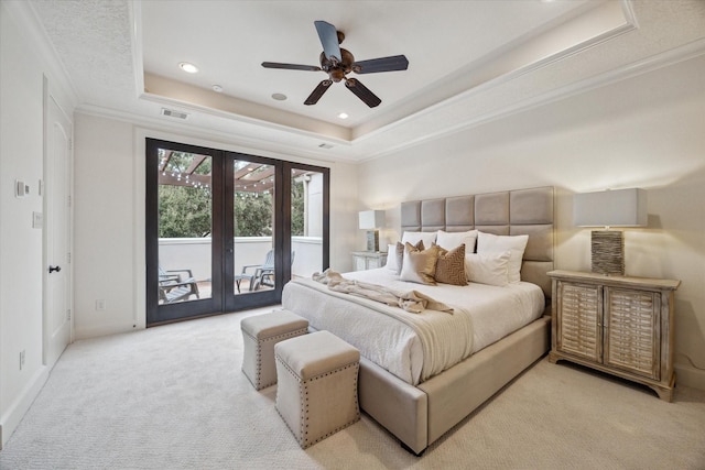 bedroom featuring a raised ceiling, crown molding, ceiling fan, french doors, and access to exterior