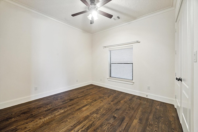 empty room with dark hardwood / wood-style flooring, a textured ceiling, ornamental molding, and ceiling fan