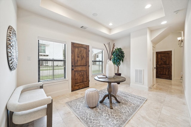 living area featuring a tray ceiling