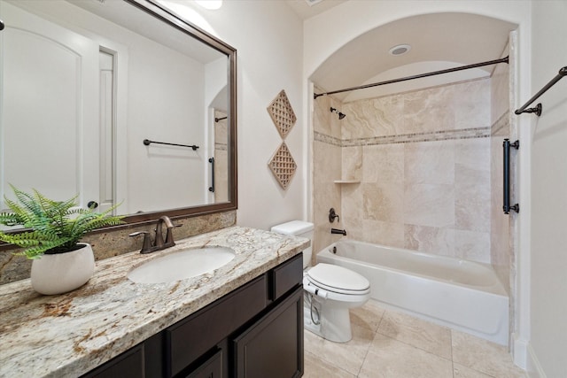 full bathroom featuring toilet, tiled shower / bath combo, tile patterned flooring, and vanity