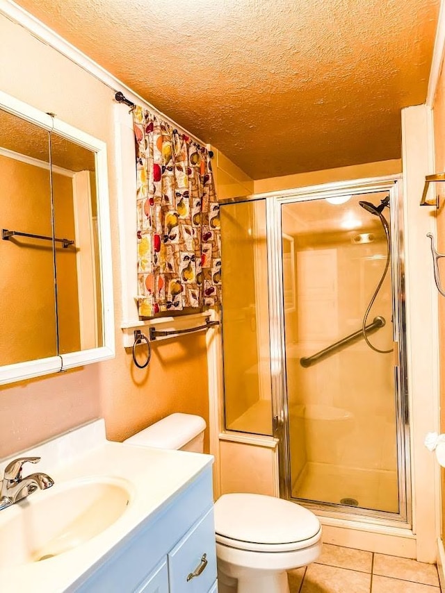 bathroom featuring toilet, a textured ceiling, tile patterned floors, an enclosed shower, and vanity