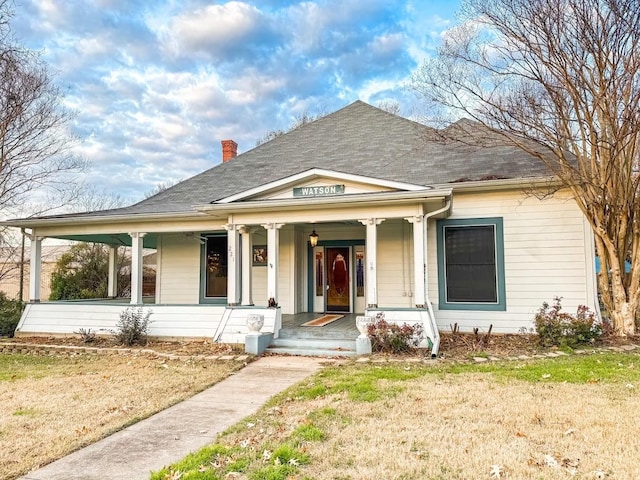 bungalow-style home featuring a porch and a front yard