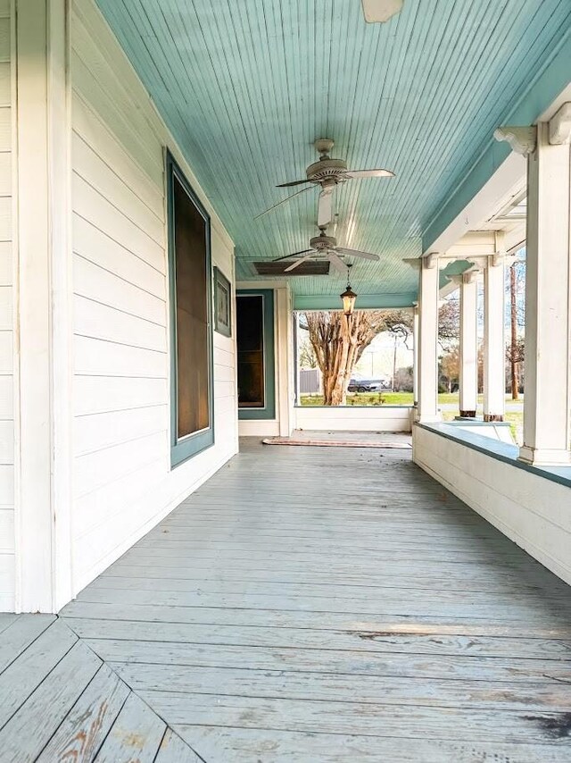 deck with ceiling fan and a porch