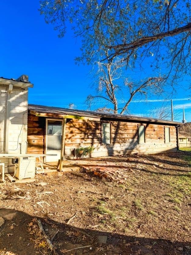 rear view of property with ac unit