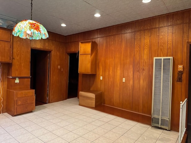 tiled empty room featuring wooden walls