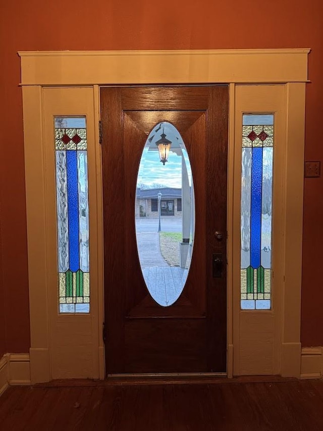 entryway with dark hardwood / wood-style flooring