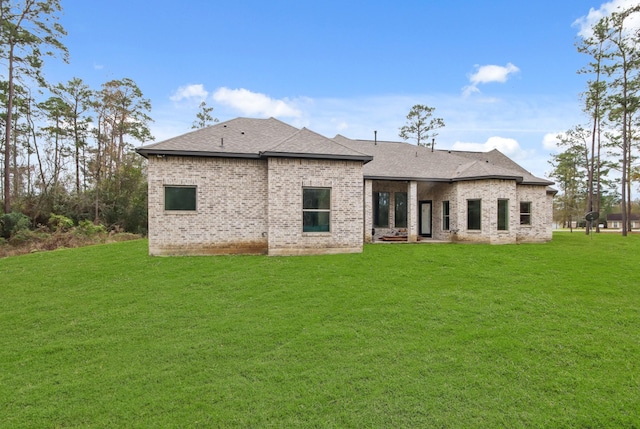 back of property with a lawn