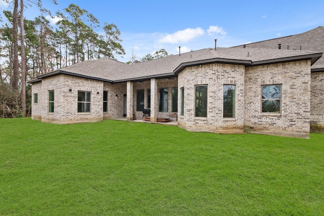 back of house with a lawn