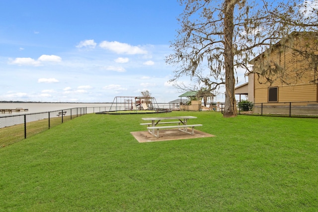 view of yard with a playground and a water view