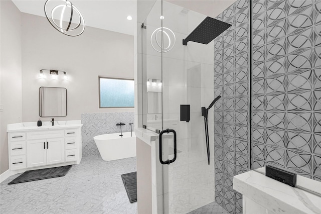 bathroom with tile walls, vanity, and shower with separate bathtub