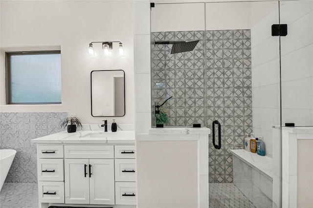 bathroom featuring vanity and independent shower and bath
