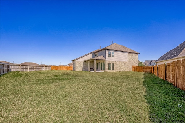 rear view of property with a lawn