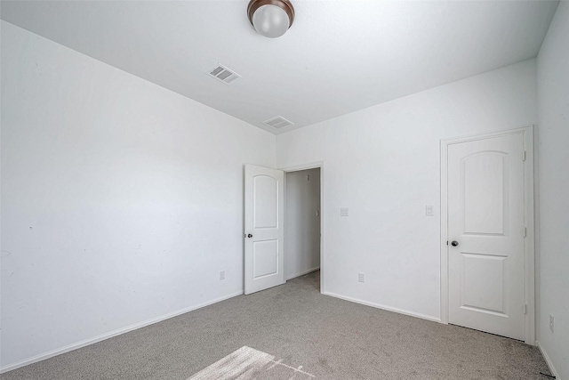 unfurnished room featuring light colored carpet