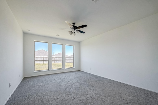 unfurnished room with carpet flooring and ceiling fan