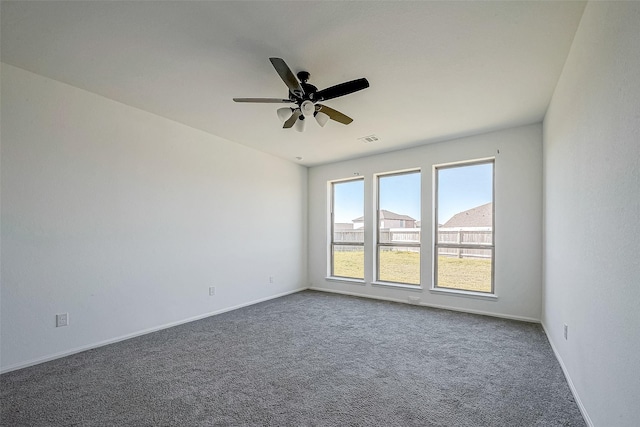 carpeted spare room with ceiling fan