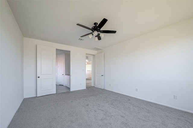 unfurnished bedroom with ceiling fan and light colored carpet