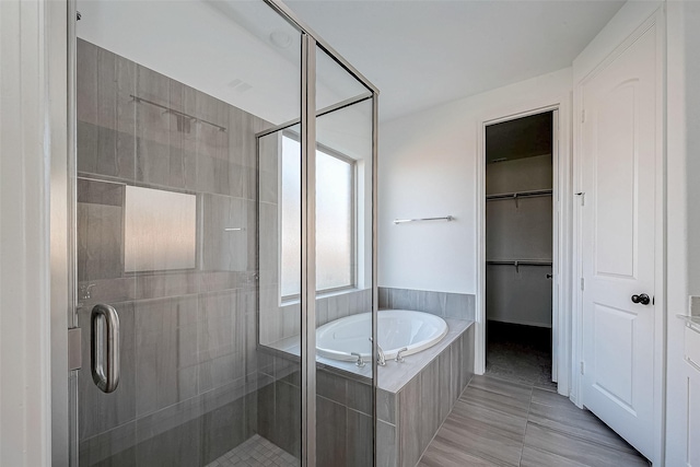 bathroom featuring tile patterned flooring and independent shower and bath