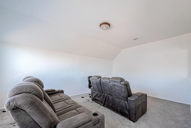 home theater room featuring carpet and vaulted ceiling