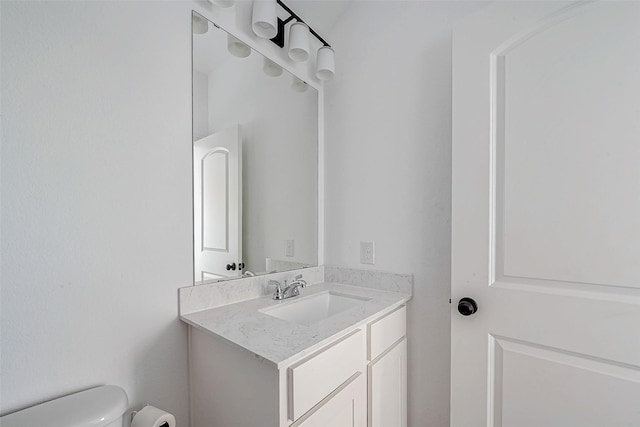 bathroom featuring toilet and vanity