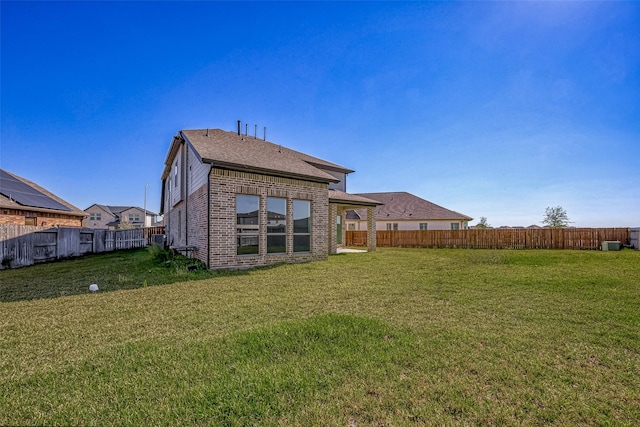 back of house with a lawn