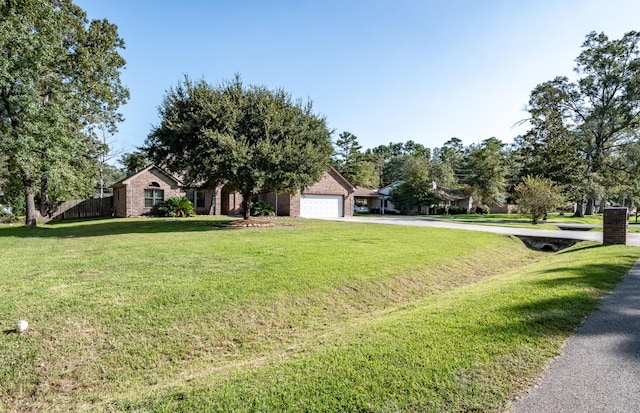 view of front of house with a front yard and a garage