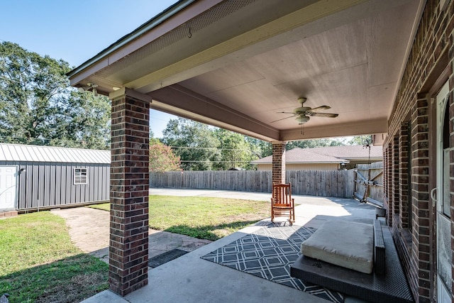 view of patio featuring ceiling fan and a storage shed